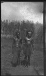 Men with feather head pieces, and a crescent shell valuable necklace called kina, on Gaorbari Island