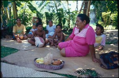 Group sitting on mats under trees