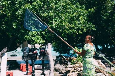Co-collector Siniva Kalolo holding fishing net, Atafu, Tokelau