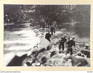 BOUGAINVILLE, 1945-05-18. TROOPS OF 57/60 INFANTRY BATTALION WADING ACROSS THE FORD AT DURHAMS CROSSING DURING THE ADVANCE ALONG THE AXIS OF THE COMMANDO ROAD SOUTH OF THE HONGORAI RIVER