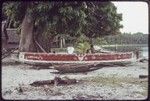 Canoes on the beach at Wawela village, including red-painted kula canoe with "Kairiyewa" written on the side