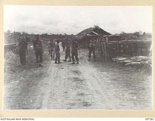 BUIN AREA, BOUGAINVILLE. 1945-09-13. MEMBERS OF THE AUSTRALIAN SURRENDER PARTY FROM HEADQUARTERS 2 CORPS, ACCOMPANIED BY JAPANESE STAFF OFFICERS, INSPECTING JAPANESE NAVAL AMMUNITION DUMP ON KAHILI ..