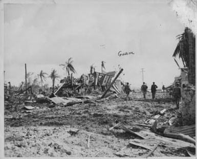 Marines advancing through the ruins of a town