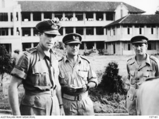 SINGAPORE, 1945-09. LORD LOUIS MOUNTBATTEN, SUPREME COMMANDER SOUTH EAST ASIA COMMAND, WITH QX6264 COLONEL W.E. LANGFORD OF TOOWOOMBA, QUEENSLAND, COMMANDING OFFICER OF THE 2/14TH AUSTRALIAN ..