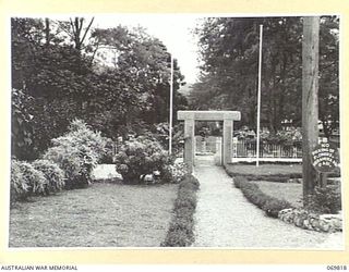 ELA BEACH, PORT MORESBY. 1954-08. THE MEMORIAL GATEWAY TO THE MEMORIAL CEMETERY AT ELA BEACH. THE GATEPOSTS ARE ENSCRIBED WITH THE NAMES OF ALL THE RESIDENTS OF PAPUA WHO ENLISTED FOR ACTIVE ..