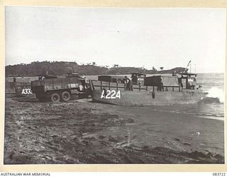 AITAPE, NEW GUINEA. 1944-11-22. A THREE TON TRUCK MOVING TO A LANDING BARGE ON THE BEACH TO ASSIST TRANSFER OF THE NEVER ENDING SUPPLIES FEEDING US AND AUSTRALIAN FORCES