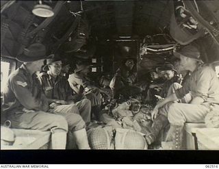 Port Moresby, New Guinea. 1944-01-05. Troops of the 2/11th Australian Light Anti-Aircraft Battery, 2/4th Australian Light Anti-Aircraft Regiment, seated in a transport aircraft with their gear at ..