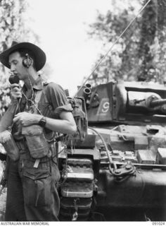 BOUGAINVILLE. 1945-04-17. CORPORAL R.L. MAAS, 24 INFANTRY BATTALION, OPERATING A 108 MK III PORTABLE WIRELESS FROM BATTALION HEADQUARTERS DURING AN ATTACK IN THE HATAI JUNCTION - BUIN ROAD AREA