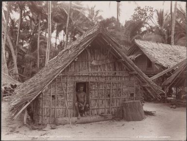 Man sitting at the entrance of a Kombe house, Florida, Solomon Islands, 1906 / J.W. Beattie