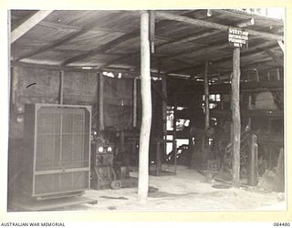 LAE, NEW GUINEA. 1944-12-18. THE ELECTRIC GENERATING SET WHICH PROVIDES POWER FOR WORKSHOP MACHINERY AND CAMP LIGHTING AT 12 SMALL SHIP COY