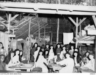 Ramale Mission, Kokopo Area, New Britain. A group of Missionary Sisters with their sewing machines at Ramale Mission. Clothes were made and repaired by them during their internment. They are ..