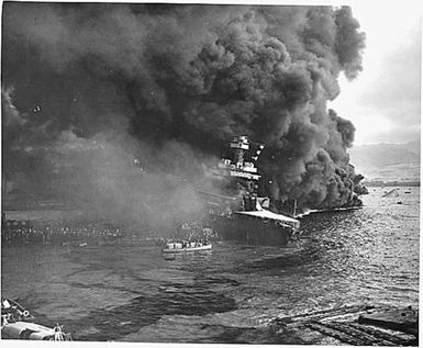 Naval photograph documenting the Japanese attack on Pearl Harbor, Hawaii which initiated US participation in World War II. Navy's caption: Abandoning ship aboard the USS CALIFORNIA after the ship had been set afire and started to sink from being attacked by the Japanese in their attack on Pearl Harbor on Dec. 7, 1941.