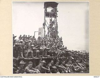 HERBERTON RACECOURSE, WONDECLA, ATHERTON TABLELAND, QLD. 1945-01-19. THE CROWD AT HQ 9 DIVISION WATCHING ATHLETIC EVENTS DURING THE 9 DIVISION GYMKHANA