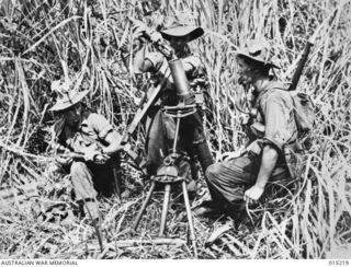 Wau-Mubo Area, along the Mubo Track members of a mortar section. Identified, left to right: Private (Pte) K McLeod, of Mallacoota, Vic; VX115546 Pte Neil McColl Gilmour, 24th Battalion, of Mont ..