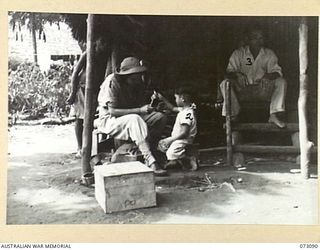 BASU RIVER VALLEY, NEW GUINEA. 1944-05-14. SUSAN TATE, A REPRESENTATIVE OF THE AMERICAN RED CROSS SOCIETY (1), WITH AH TUNG (2), THE SON OF SETO KONG (3), AT A CHINESE FARMING VILLAGE APPROXIMATELY ..