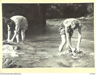 ILIMO, NEW GUINEA. 1944-04-15. NX12322 LANCE-CORPORAL A.E. PARTRIDGE, A MEMBER OF THE AUSTRALIAN ARMY MEDICAL CORPS (1), WITH SX27999 SIGNALMAN W. JENKINS, 24TH LINE SECTION, 18TH LINES OF ..