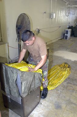 US Air Force (USAF) AIRMAN First Class (A1C) Oscar Hurtado from the 7th Expeditionary Maintenance Squadron (EMXS), packs a drag-chute for a B-52 Stratofortress bomber, at Andersen Air Force Base (AFB), Guam