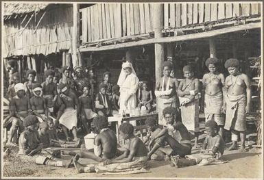 Glimpses around Wanigella [Wanigela], [nurse and a group of people wearing bandages] Frank Hurley