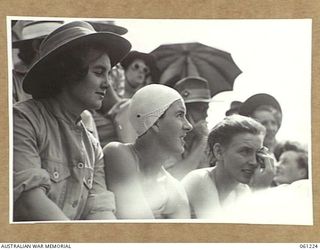 PORT MORESBY, NEW GUINEA. 1943-11-28. SERVICE WOMEN SPECTATORS AT THE ALLIED FORCES GRAND SWIMMING CARNIVAL