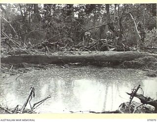 GOALING RIVER AREA, WEST NEW GUINEA. 1944-01-25. SALVAGEABLE EQUIPMENT ABANDONED BY THE JAPANESE SHOWING DAMAGE CAUSED THROUGH FIRES RESULTING FROM THREE DIRECT HITS BY OUR BOMBER AIRCRAFT. CASES ..