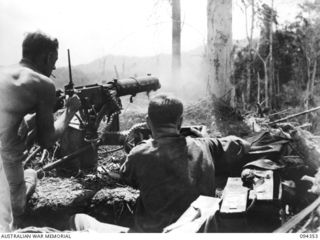 ULUNKOHOITU, YAMIL AREA, NEW GUINEA, 1945-07-18. PTE J.L. BEARD (1) AND CPL C.H. HUTCHINSON (2), MEMBERS OF 8 PLATOON, A COMPANY, 2/6 INFANTRY BATTALION, REPLYING WITH RAPID FIRE ON THEIR VICKERS ..