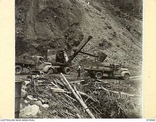 ZENAG, NEW GUINEA, 1944-02-27. A QUICKWAY TRUCK SHOVEL FROM NO.4 PLATOON, 2/1ST MECHANICAL EQUIPMENT COMPANY, ROYAL AUSTRALIAN ENGINEERS LOADING MATERIAL FROM THE SHALE FACE FOR THE SURFACING OF ..