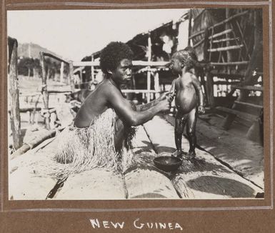 A woman bathing a child, Port Moresby, 1914