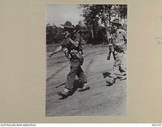 WEWAK AREA, NEW GUINEA. 1945-05-13. PRIVATE S.W. GINN (1), AND PRIVATE J.M. FILMORE (2) OF 2/8 INFANTRY BATTALION, MARCHING ALONG BORAM BEACH NEAR WEWAK ON THEIR WAY TO RELIEVE THE 2/4 INFANTRY ..
