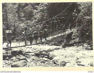 FARIA VALLEY, NEW GUINEA, 1944-02-09. MEMBERS OF THE 2/10TH INFANTRY BATTALION, 18TH INFANTRY BRIGADE, CROSSING THE FARIA RIVER NEAR GUY'S POST. THEY ARE MOVING FROM FORWARD POSITIONS IN THE ..