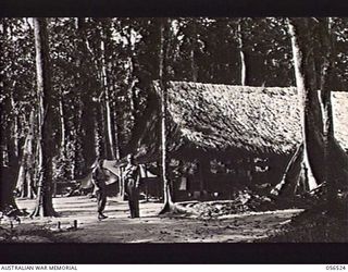 REINHOLD HIGHWAY, NEW GUINEA, 1943-09-04. REGIMENTAL AID POST BUILDING AT HEADQUARTERS, BULLDOG BASE AREA. NX136038 SERGEANT J. A. HALLORAN (LEFT); NX83201 CORPORAL N. A. BIBO