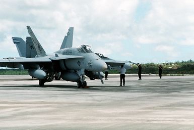 Ground crew members conduct a preflight check on a Marine Fighter-Attack Squadron 232 (VMFA-232) F/A-18C Hornet aircraft during Operation Tandem Thrust '93