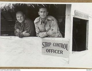 DUMPU, NEW GUINEA. 1944-01-16. VX89871 GUNNER I. G. SHARP (1) AND NX116227 LIEUTENANT S. K. SAUL, STRIP CONTROL OFFICER (2) AT THE NO. 2 STRIP