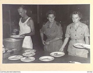 TOROKINA, BOUGAINVILLE, 1945-04-18. SISTER M. WALL (2), SUPERVISING THE SERVICE OF BREAKFAST IN THE SISTERS KITCHEN AT 2/1 GENERAL HOSPITAL. IDENTIFIED PERSONNEL ARE:- PRIVATE WORRAD (1); CORPORAL ..