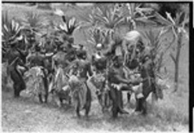 Church service in Kwiop: decorated men dance with kundu drums