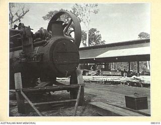 BUSU FOREST, LAE AREA, NEW GUINEA. 1944-07-26. THE SPARE STEAM ENGINE STANDING IN THE MILL YARD AT THE 2/3RD FORESTRY COMPANY, ROYAL AUSTRALIAN ENGINEERS