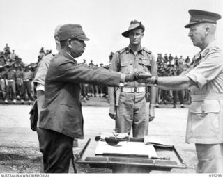 Signing of surrender documents by Lieutenant General (Lt Gen) Hatazo Adachi, Commander of the Japanese 18th Army in New Guinea. After signing the unconditional surrender, Lt Gen Adachi is ordered ..