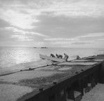 Men launch skiff into water, Bikini Atoll