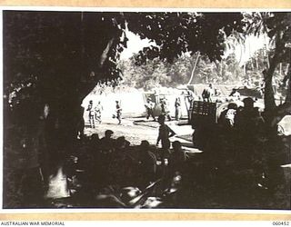 FINSCHHAFEN AREA, NEW GUINEA. 1943-11-09. UNLOADING SUPPLIES AND TROOPS AT KEDAM BEACH, THE MAIN SUPPLY POINT FOR THE 870TH UNITED STATES ENGINEER AVIATION BATTALION. THIS UNIT IS PREPARING THE ..