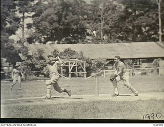 MADANG, NEW GUINEA. 1944-12-28. IN A GAME OF CRICKET 50062 CORPORAL E. J. STYLES, MORDIALLOC, VIC, MAKES THE MOST OF A LOOSE BALL AND SENDS IT TO THE BOUNDARY WHILE THE WICKET-KEEPER 407162 ..