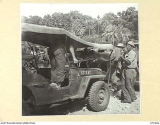 LAUNCH JETTY, NEW GUINEA: 1944-01. A PATIENT BEING UNLOADED FROM AN AMBULANCE JEEP OF THE ADVANCED DRESSING STATION, LAUNCH JETTY, 10TH FIELD AMBULANCE