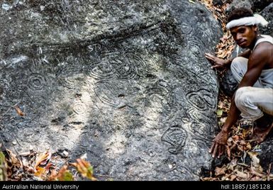 Incised boulder, close up of the ancient incisions on a boulder in the River Mwadeya, called Kwaianawanawala (white playings or doodles) used as a boundary marker