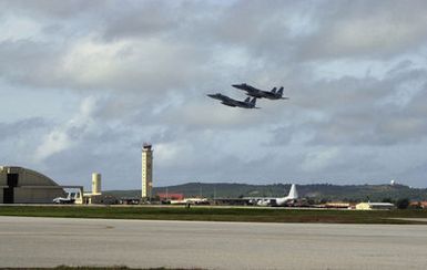 A pair of Japan Air Self Defense Force (JASDF) F-15 Eagle fighters from the 8th Air Wing (AW) out of Tsuiki Air Base, Japan, take off in formation from Andersen Air Force Base (AFB), Guam, in support of Exercise COPE NORTH 2002