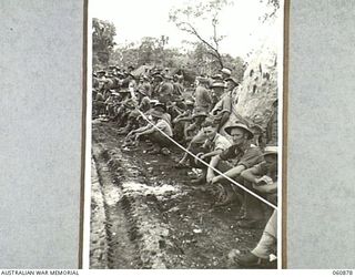 NEW GUINEA. 1943-11-20. SPECTATORS WATCHING THE EVENTS AT THE 18TH AUSTRALIAN INFANTRY BRIGADE SPORTS MEETING WHICH WAS HELD TO CELEBRATE THE FOURTH ANNIVERSARY OF THE FORMATION OF THE UNIT. SEEN ..