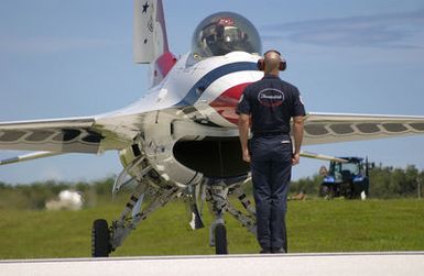 U.S. Air Force TECH. SGT. Brian Plauche, a Crew CHIEF assigned to the U.S. Air Force Thunderbirds Aerial Demonstration Team, marshals the F-16C Fighting Falcon aircraft"Thunderbird 8"into position, after the Team Landed at Andersen Air Force Base, Guam, September 9, 2004. This landing marks the first time in a decade the USAF Thunderbird demonstration team has visited Guam. The Thunderbirds will be performing during an air show held Sunday, September 12, 2004. (U.S. Air Force PHOTO by STAFF SGT. Bennie J. Davis III) (Released)