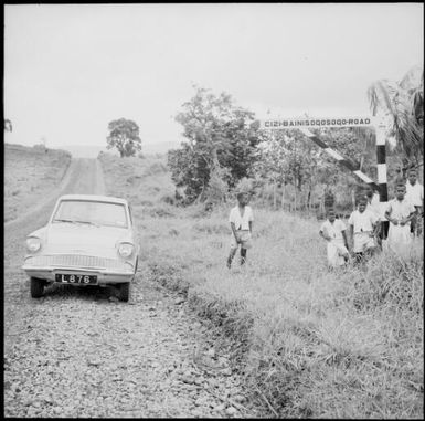 Fijians standing beside road sign, Fiji, November 1966 / Michael Terry