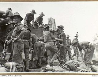 PORT MORESBY, PAPUA, NEW GUINEA. 1944-01-05. TROOPS OF THE 58/59TH AUSTRALIAN INFANTRY BATTALION, 15TH AUSTRALIAN INFANTRY BRIGADE EMBUSSING FOR THEIR TRIP TO THE AIRSTRIP WHEN TRANSFERRING TO ..