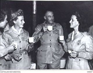 RABAUL, NEW BRITAIN, 1946-02-06. MAJOR GENERAL K.W. EATHER, GENERAL OFFICER COMMANDING 11 DIVISION, CHATTING WITH MEMBERS OF 6 ENTERTAINMENT UNIT, AUSTRALIAN ARMY AMENITIES SERVICE, AT A SUPPER ..