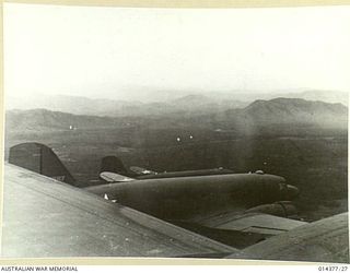 1943-03-03. ARMY AIR TRANSPORT. DOUGLAS TRANSPORT PLANES OF THE U.S. ARMY FLYING IN FORMATION ABOVE THE BULOLO VALLEY. HILLS SUCH AS THOSE IN THE BACKGROUND STRETCH FOR HUNDREDS OF MILES. (NEGATIVE ..