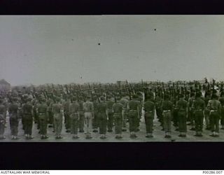 CAPE WOM, WEWAK SECTOR, NEW GUINEA, 1945-09-13. 6TH DIVISION, AIF, ON PARADE FOR SURRENDER CEREMONY OF LIEUTENANT-GENERAL HATAZO ADACHI, COMMANDER OF THE JAPANESE 18TH ARMY, TO MAJOR-GENERAL ..