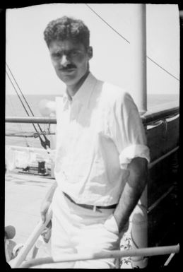 Man standing beside a ship's rail, New Guinea, ca. 1929 / Sarah Chinnery